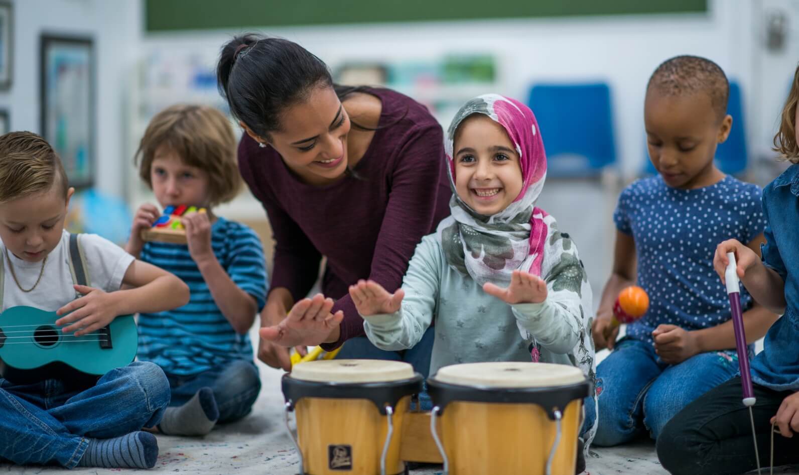 A woman with children playing instruments